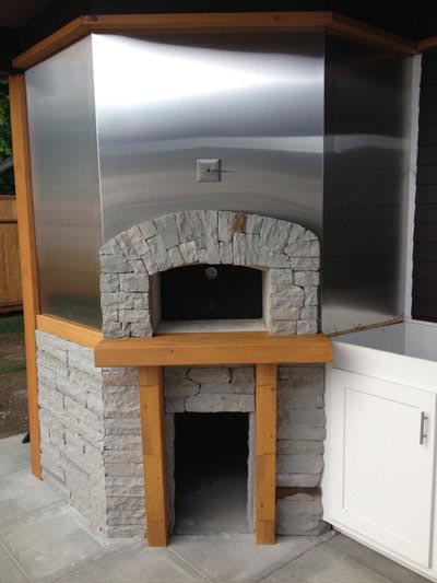 Wood fired pizza oven in outdoor kitchen